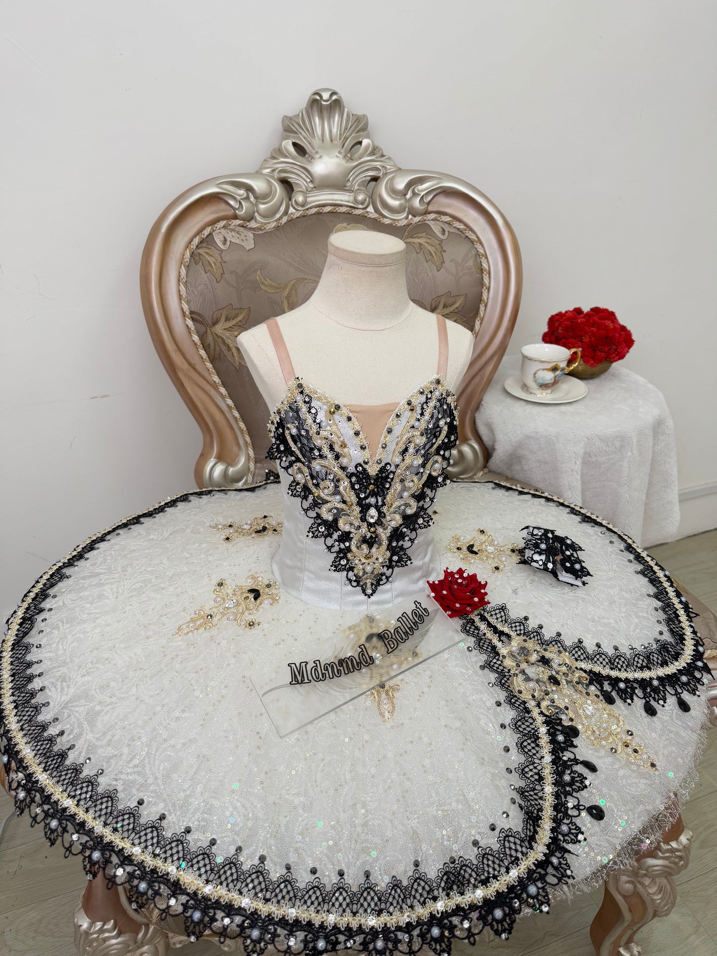 An elegant white ballet tutu adorned with lace and sequin embellishments.-MDT1282